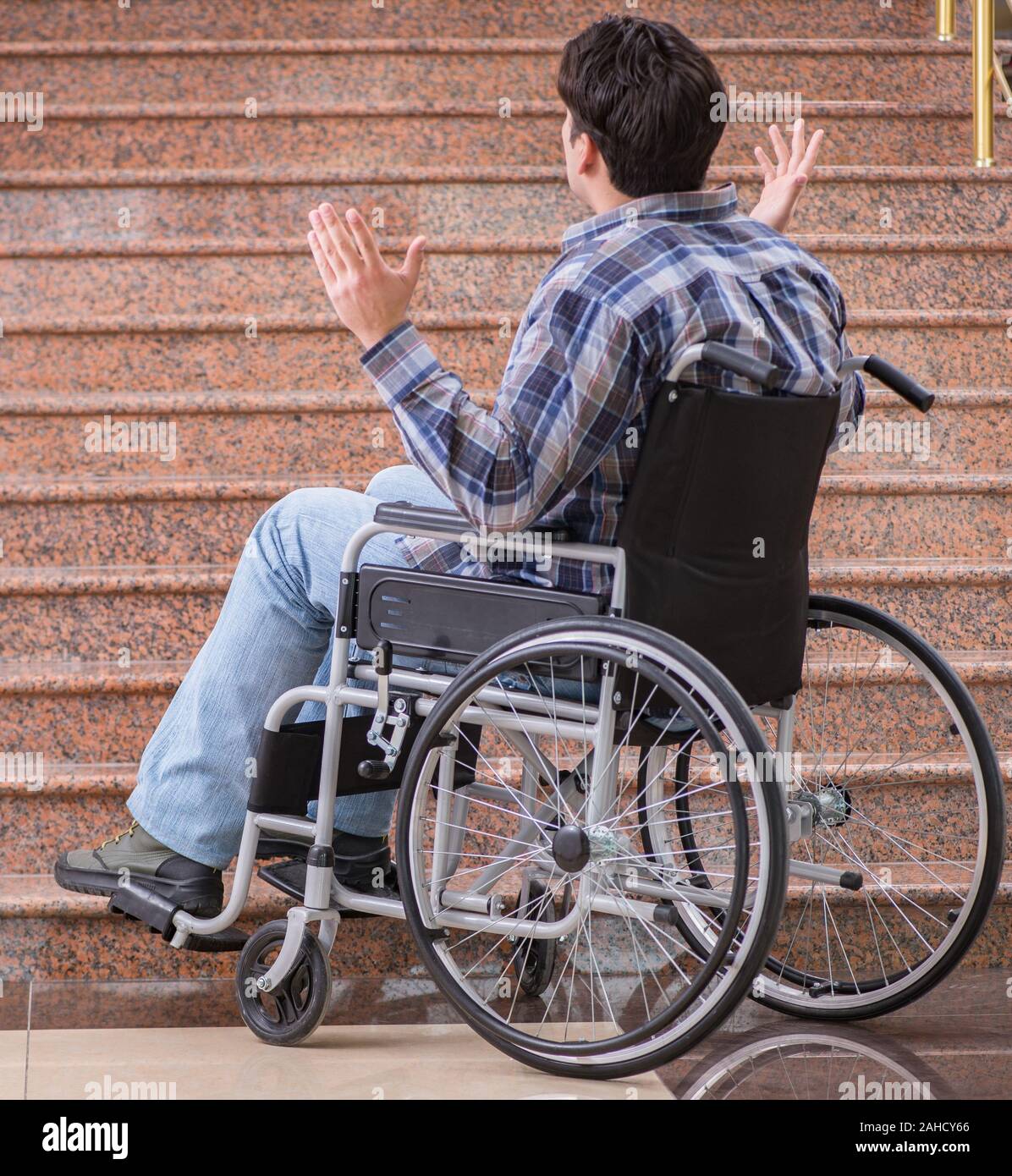 The disabled man on wheelchair having trouble with stairs Stock Photo