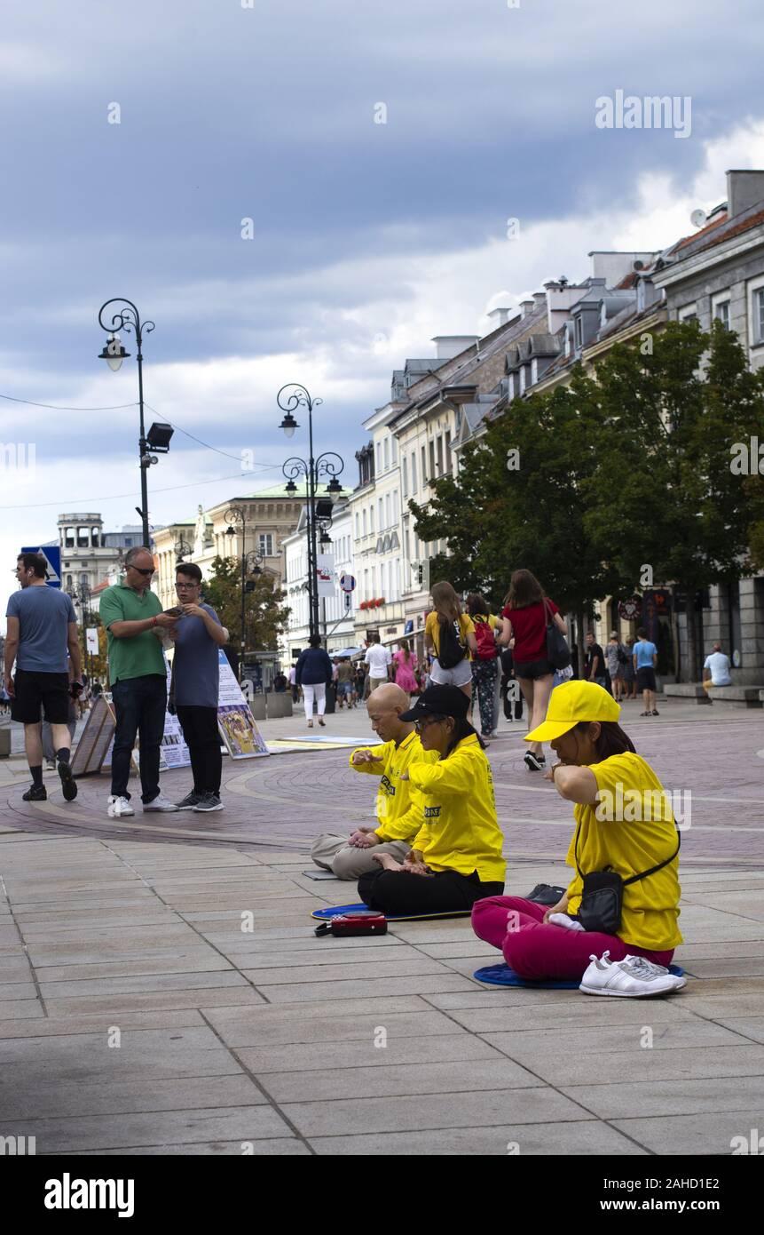 Followers of Falun Dafa during public meditation in Warsaw, Poland Stock Photo