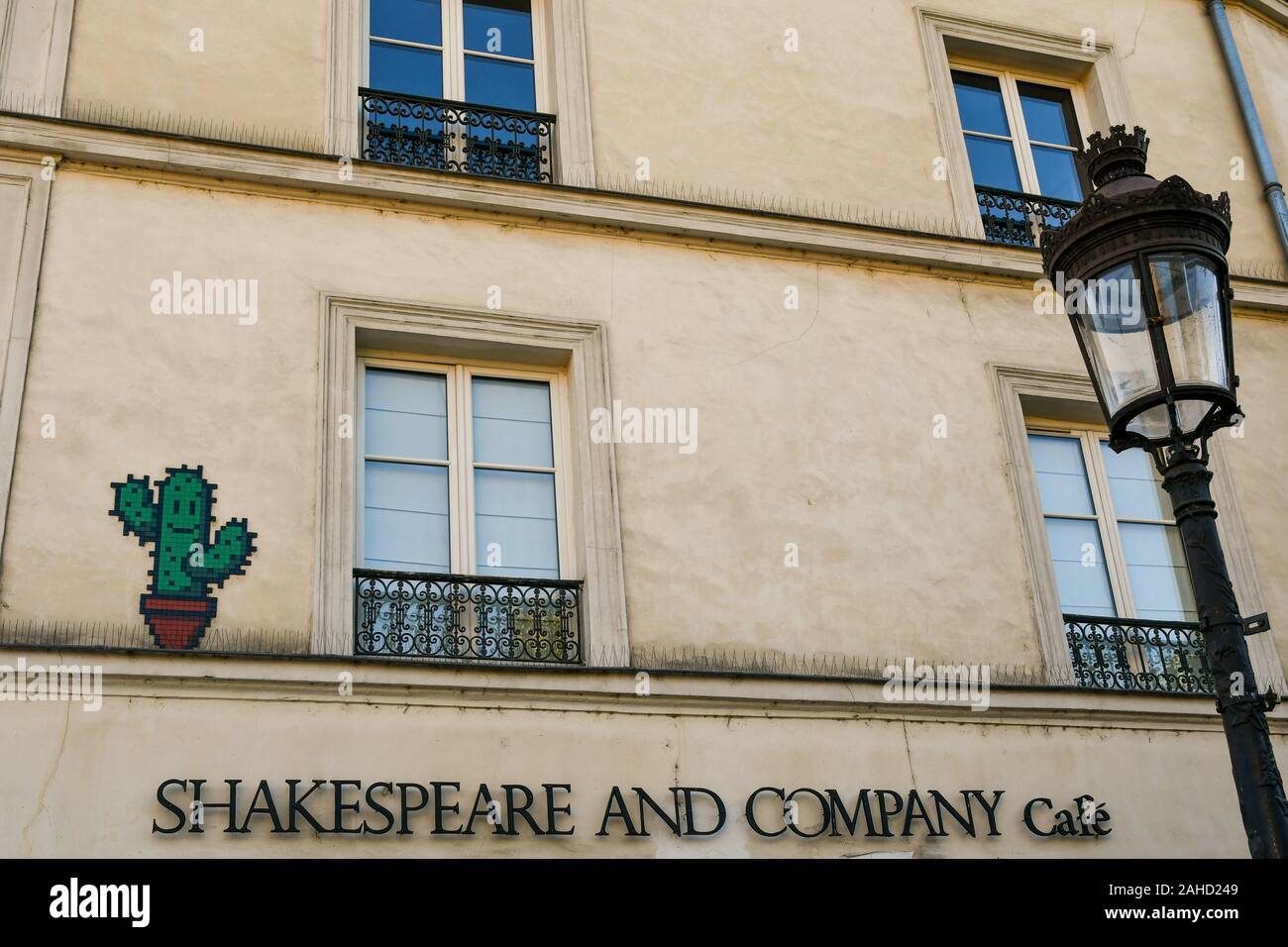 A mosaic by the street artist Invader on the façade of Shakespeare and Company historical bookstore on the Rive Gauche (Left Bank), Paris, France Stock Photo