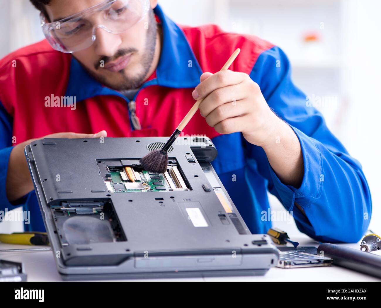 Repairman working in technical support fixing computer laptop