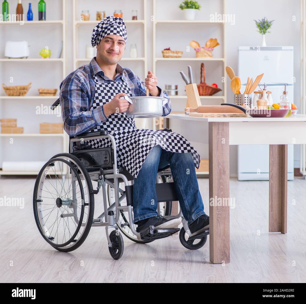 The disabled cook on wheelchair in cooking concept Stock Photo Alamy