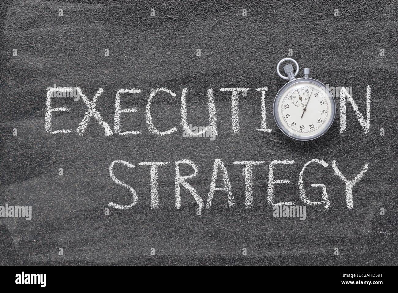 execution strategy phrase written on chalkboard with vintage precise stopwatch Stock Photo