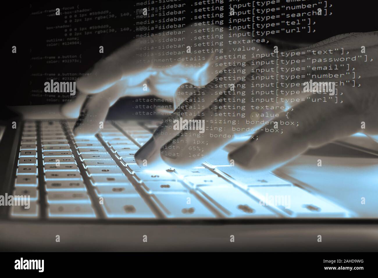 Concept of information security system - a hacker or programmer codes software on a computer at night (composite image) Stock Photo