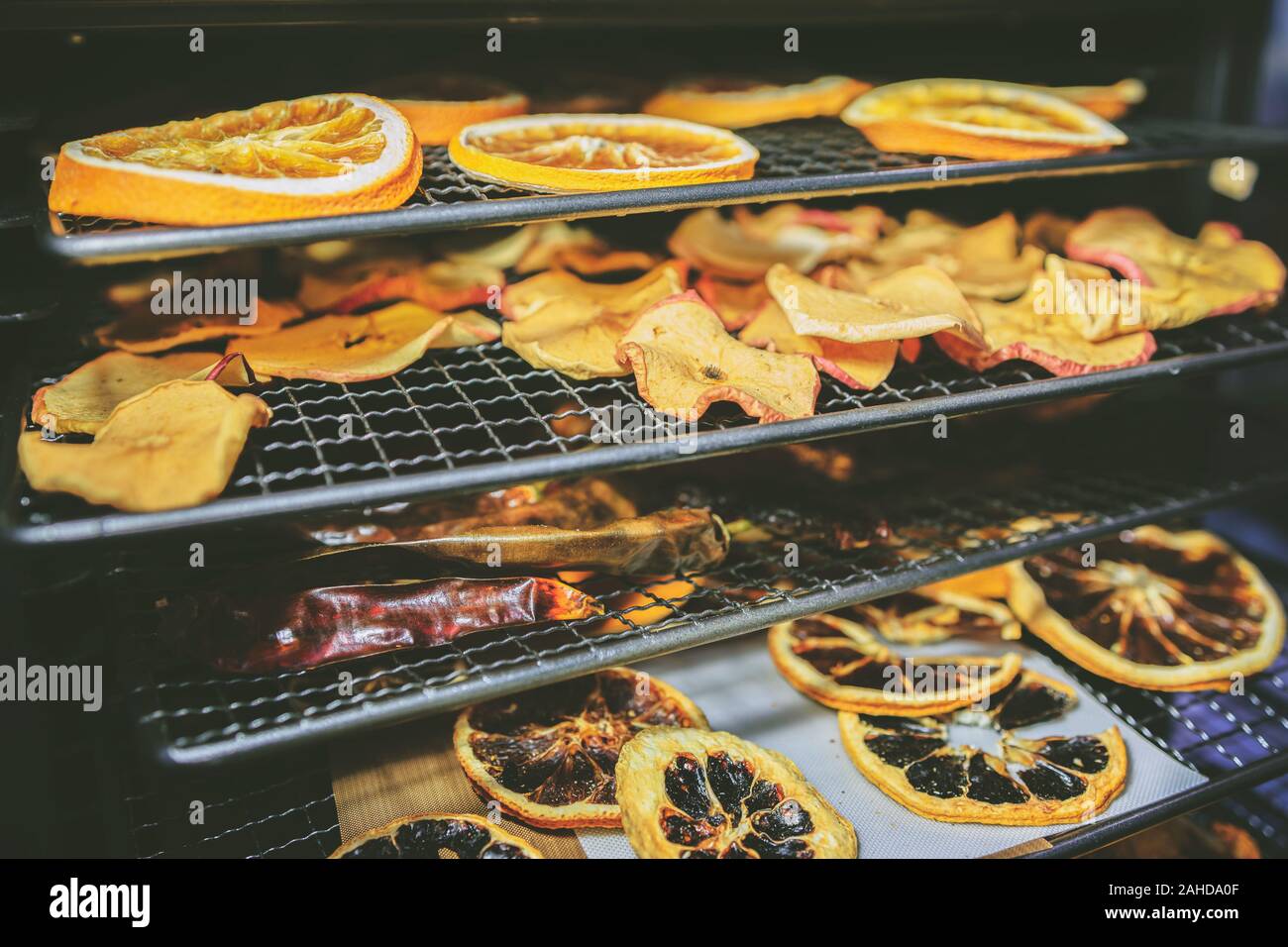 Concept of healthy home cooking - drying the fruit in the oven during the winter and holiday season (reduced tones) Stock Photo