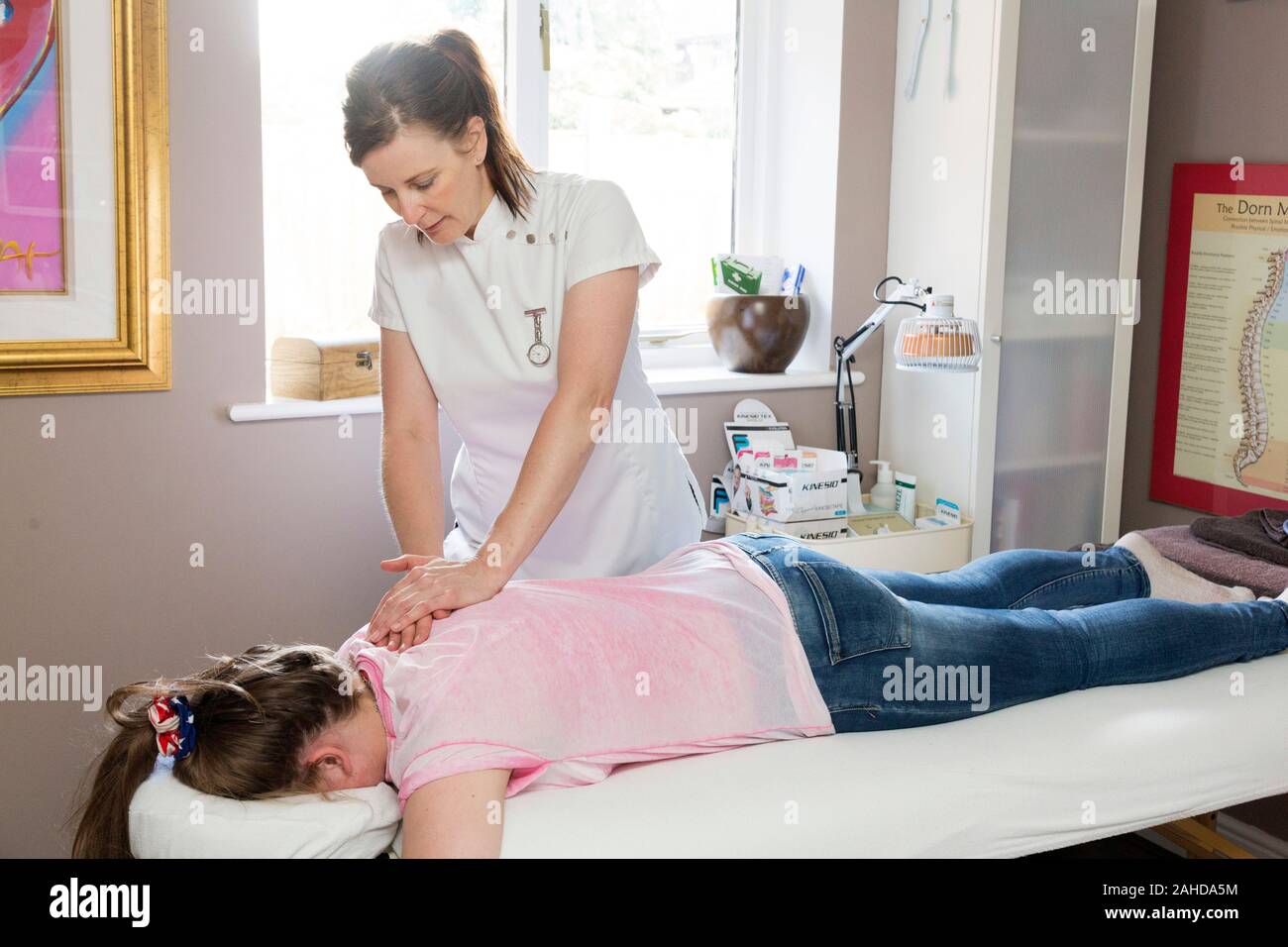 sports massage therapist treating teenage girl Stock Photo