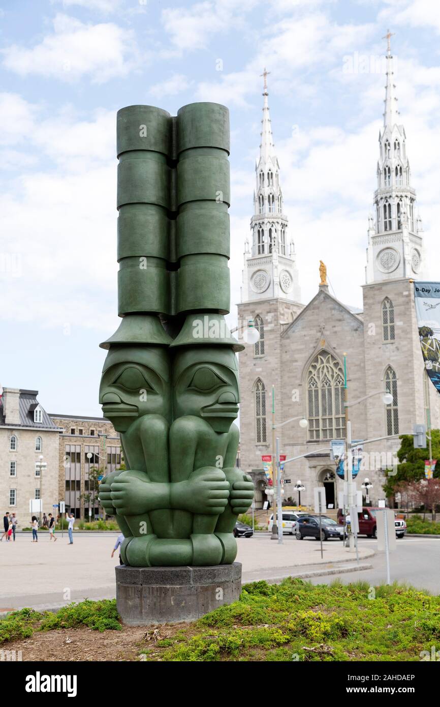 The Three Watchmen by the Notre-Dame Cathedral Basilica in Ottawa, Canada. The totem pole was created by James Hart Stock Photo