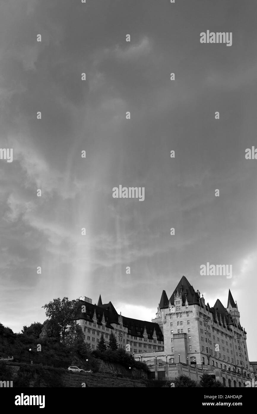 Rainstorm above the Fairmont Château Laurier hotel in Ottawa, Canada. The hotel stands next to the UNESCO World Heritage Site Rideau Canal. Stock Photo