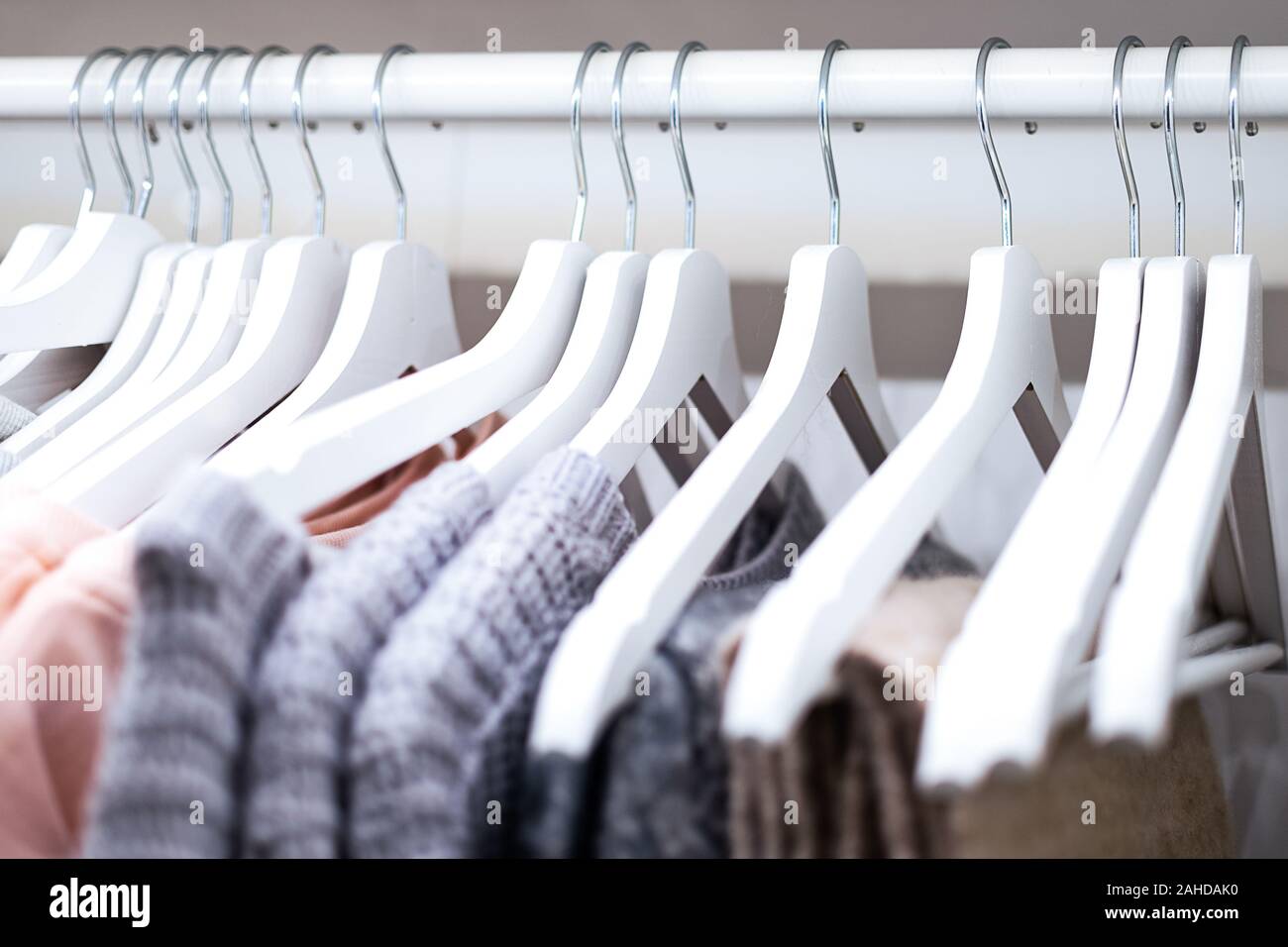 Female hanging clothes arranged on hangers in the wardrobe ( selective focus) Stock Photo