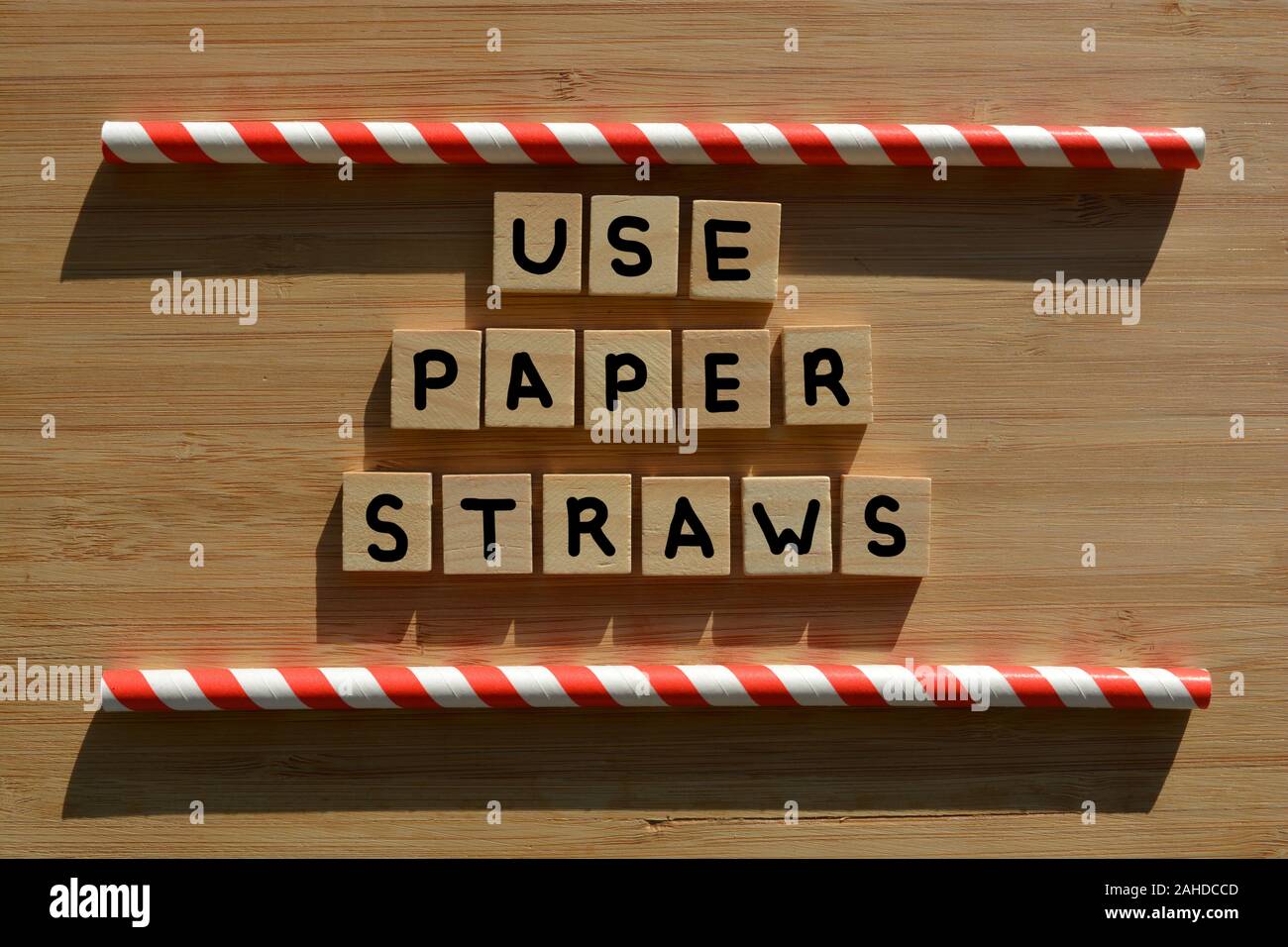 Use Paper Straws, words in 3d wooden alphabet letters on a wood