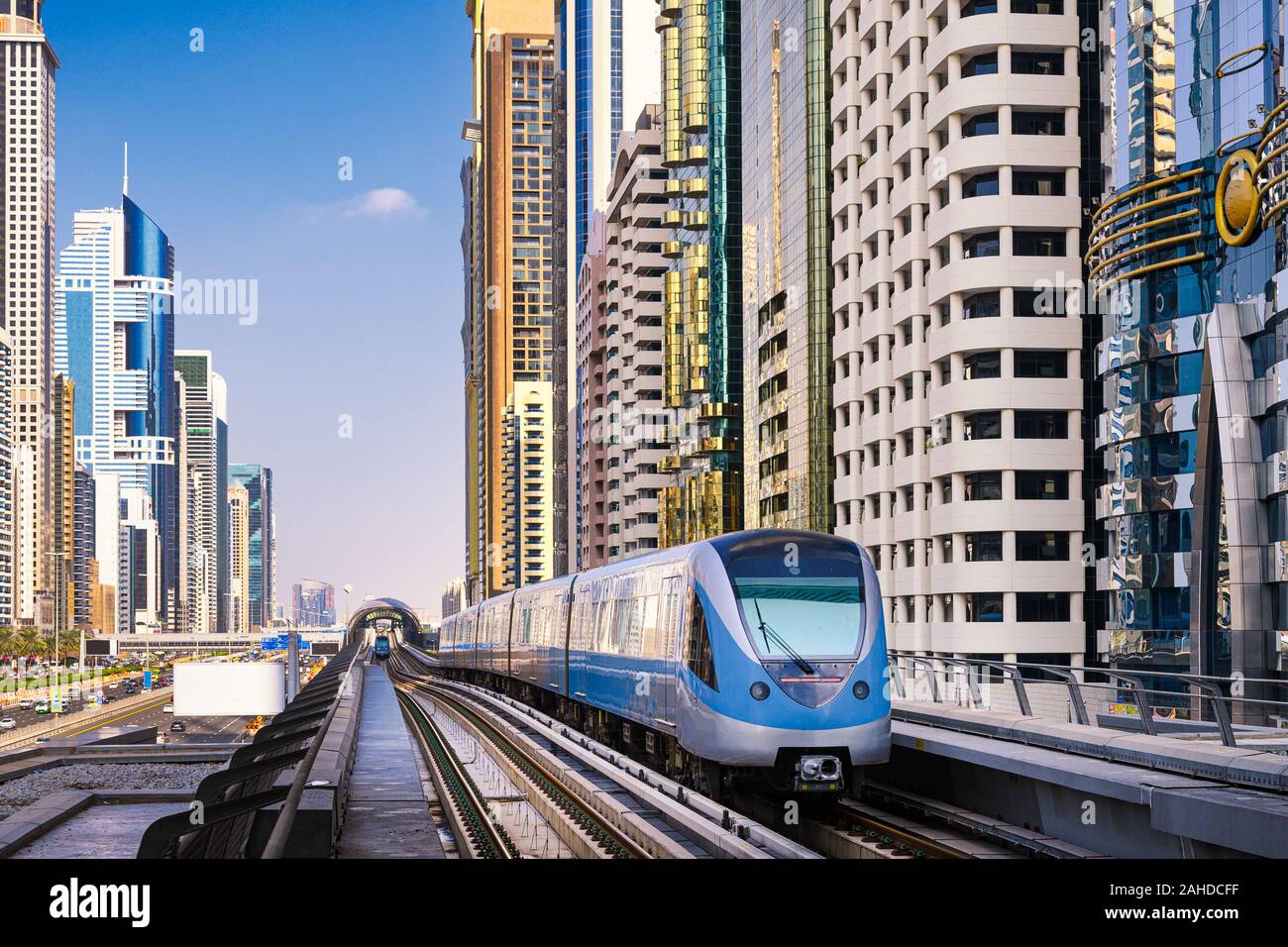 Metro train among skyscrapers of Sheikh Zayed Road in Dubai, UAE Stock Photo