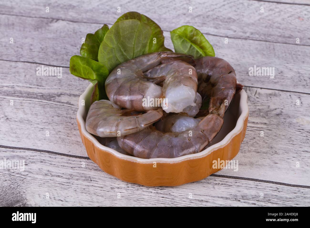 Raw king prawns ready for cooking served salad leaves Stock Photo Alamy