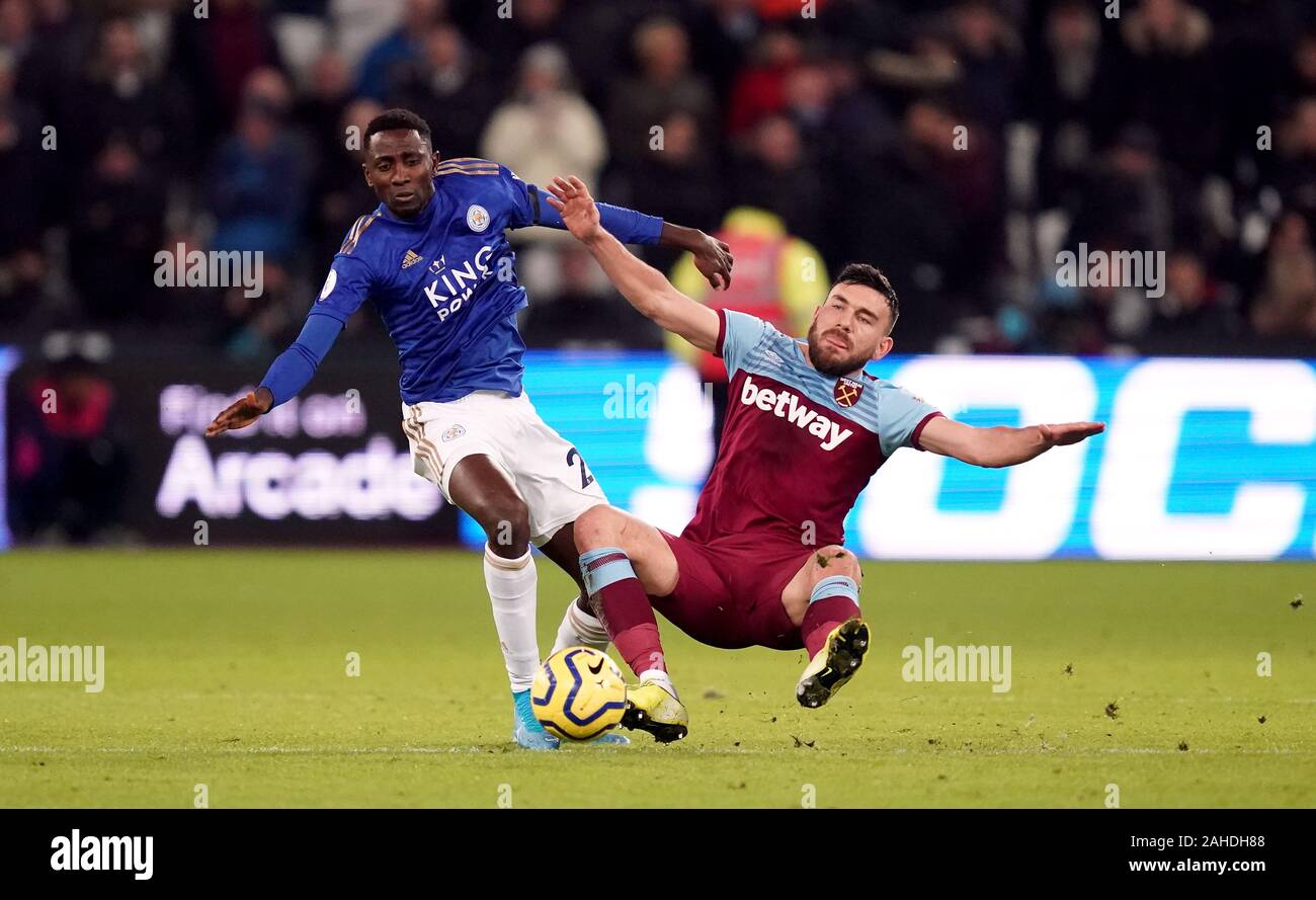 Leicester City's Wilfred Ndidi (left) and West Ham United's Robert Snodgrass battle for the ball during the Premier League match at London Stadium. Stock Photo