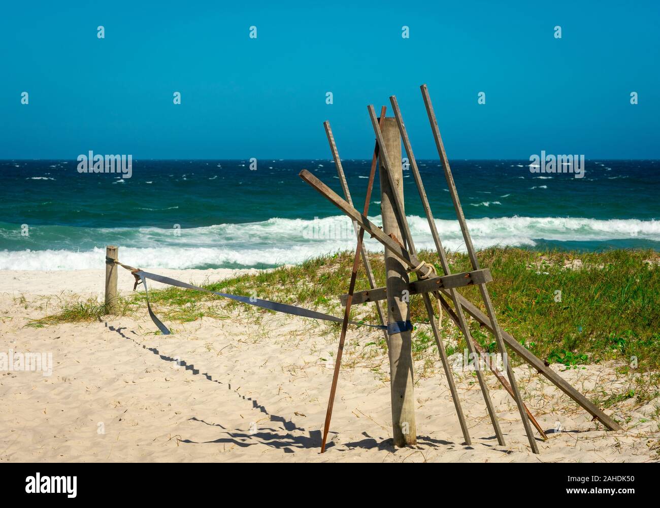 Slackline set over white sand at a tropical beach in Brazil Stock Photo