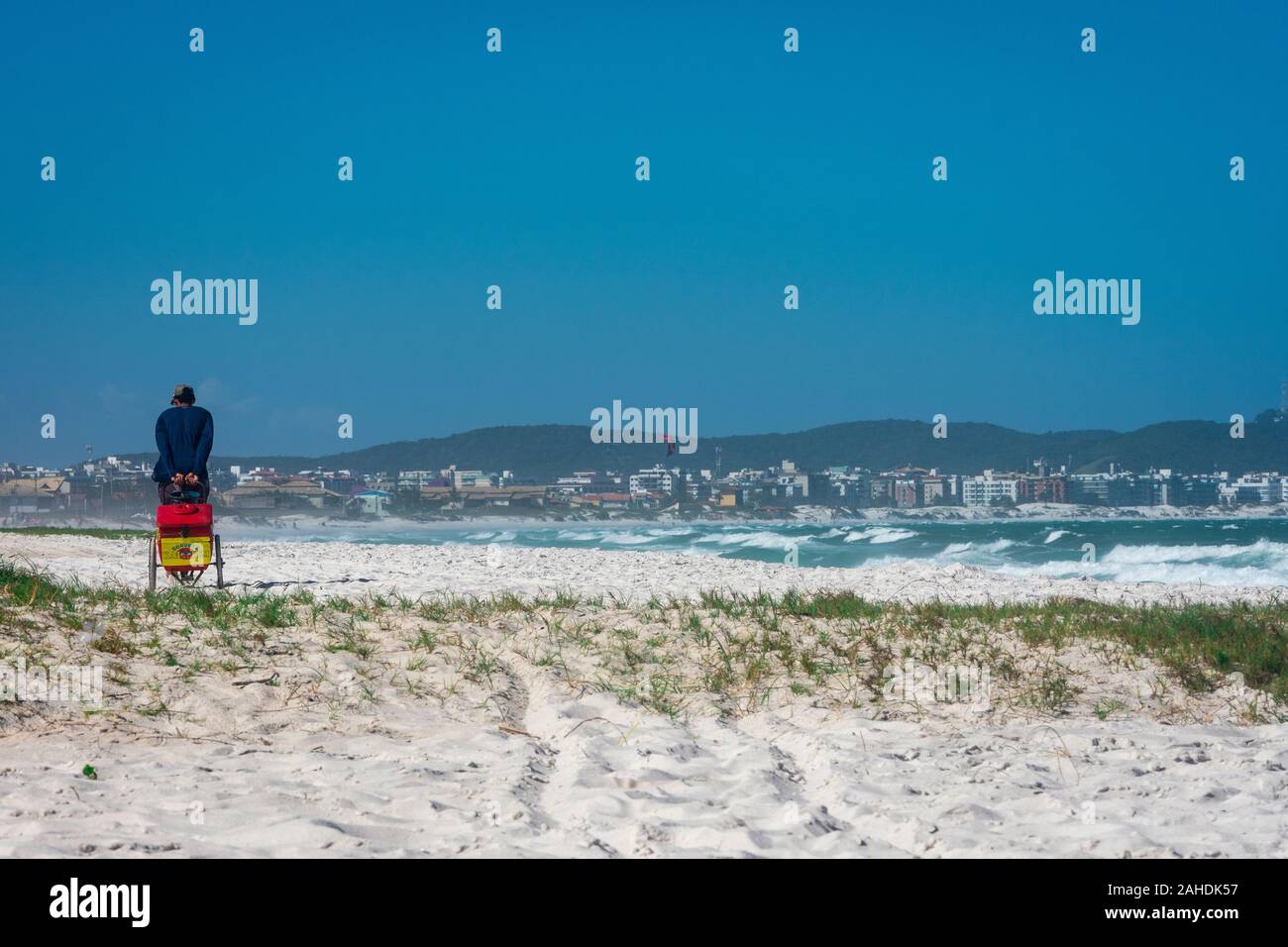Man working at an uncroweded tropical beach in Brazil. Stock Photo