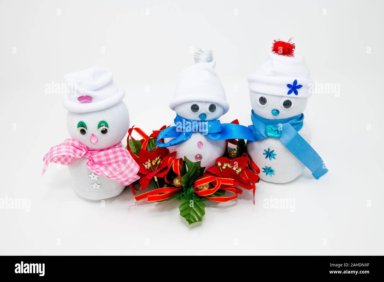 Three handmade snowmen made from white socks. Stock Photo