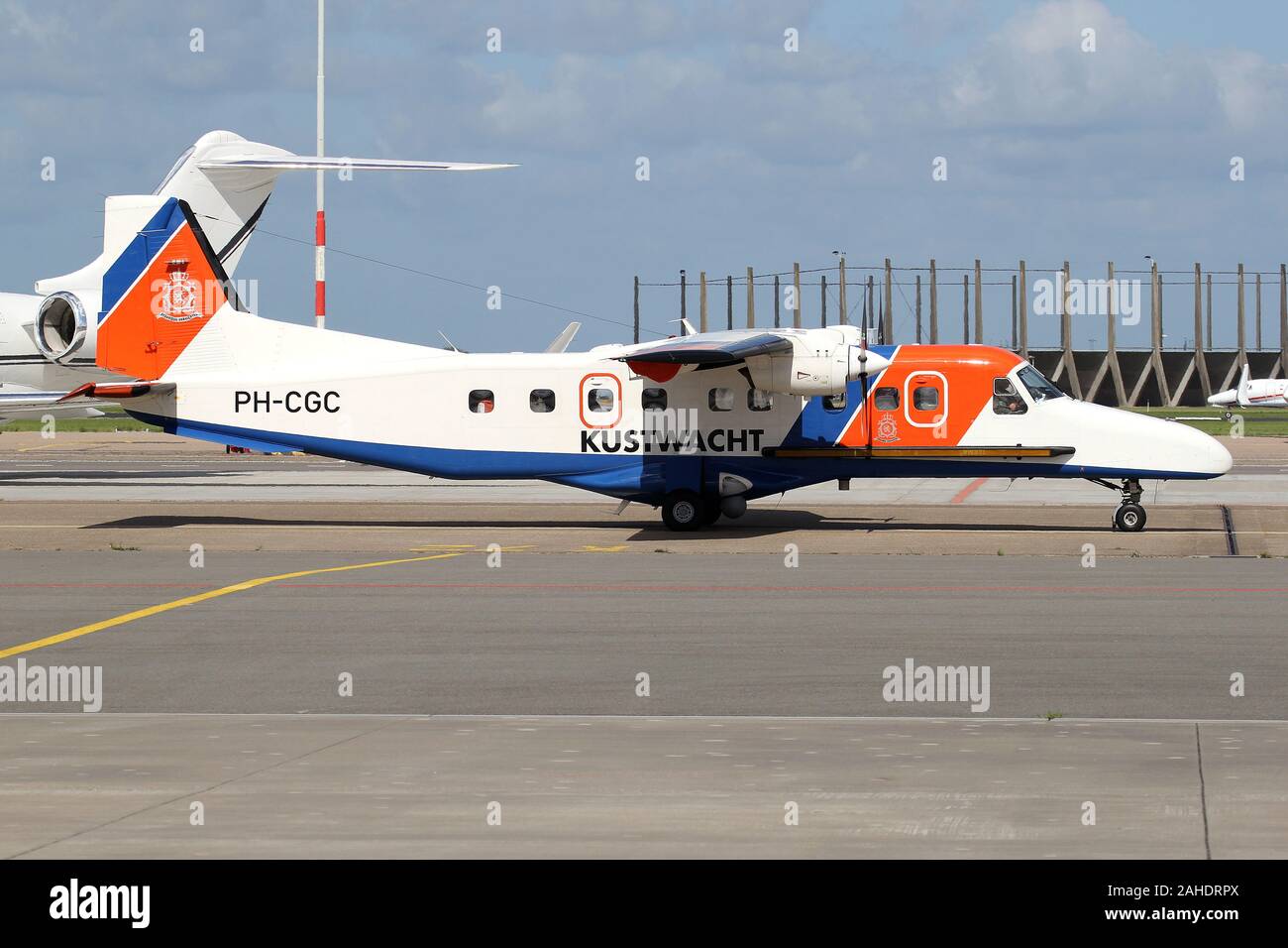 Netherlands Coastguard Dornier 228 with registration PH-CGC taxiing to parking position at Amsterdam Airport Schiphol. Stock Photo