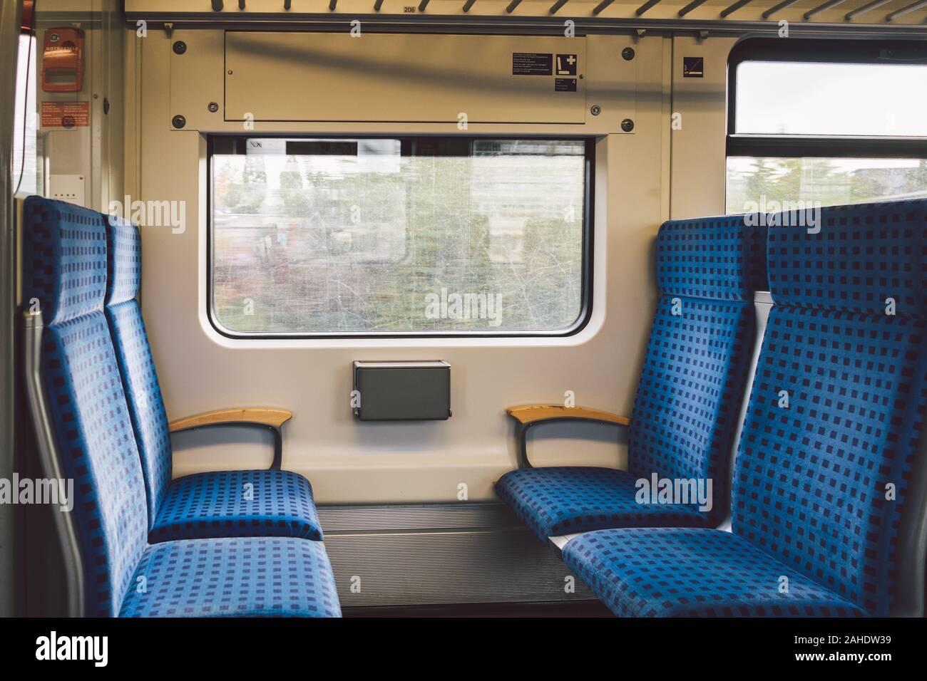 Inside The Wagon Train Germany, Dusseldorf. Empty train interior. interior view of corridor inside passenger trains with blue fabric seats of German Stock Photo