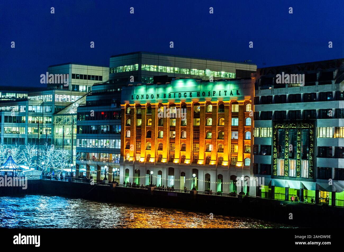 London Bridge Hospital on the banks of the River Thames at dusk in London, UK, with copy space. Stock Photo