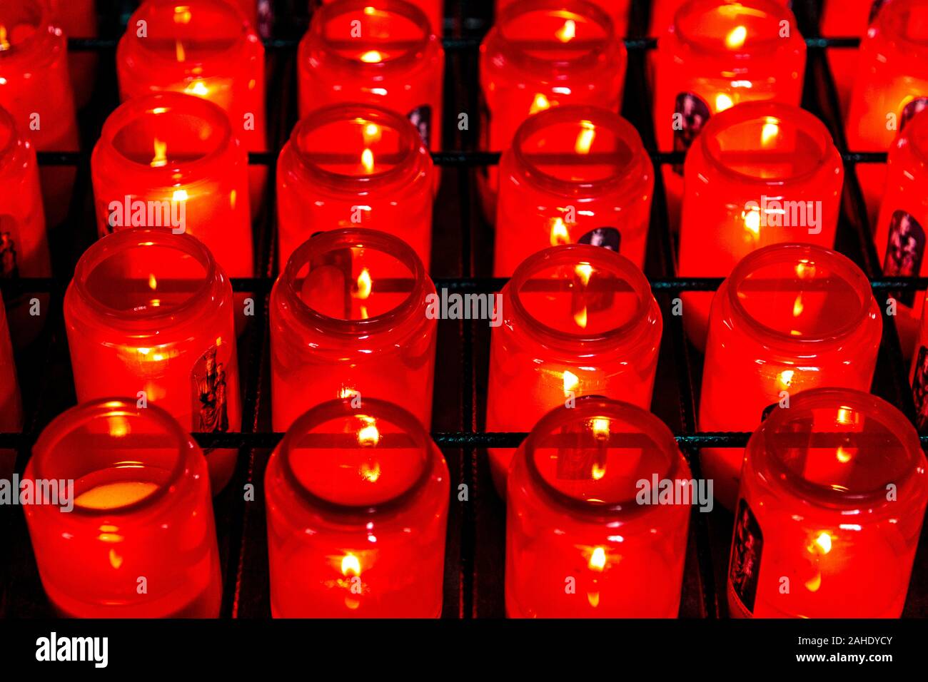 Lit candles inside the chapel Ten Wijngaerde (Begijnhof Brugge Monastery), Bruges, Belgium Stock Photo