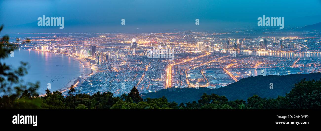 Panoramic view of Da Nang City as seen from Ban Co Peak viewpoint after sunset, Vietnam. Stock Photo