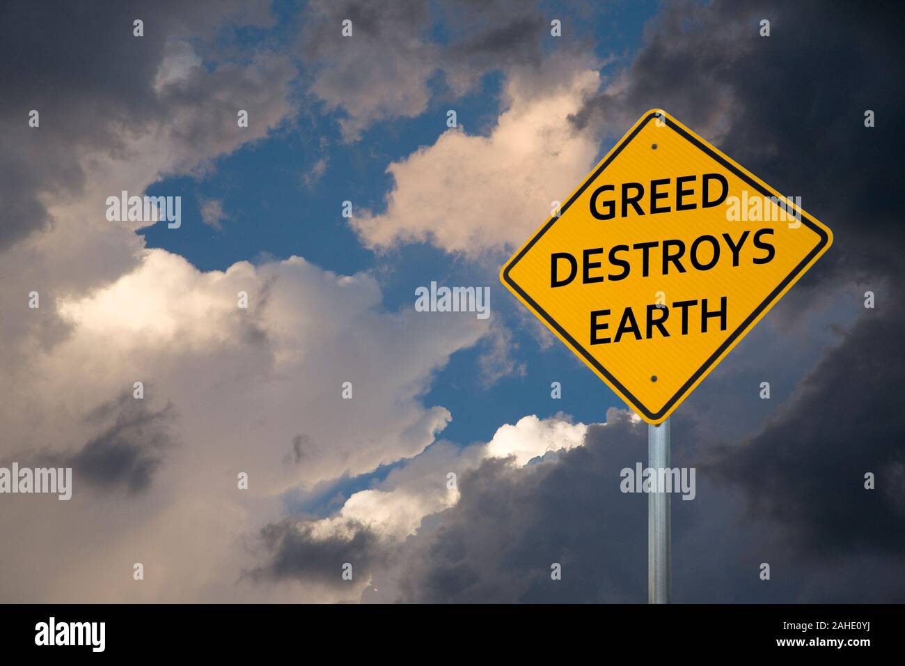 'GREED DESTROYS EARTH' Road Sign Stock Photo