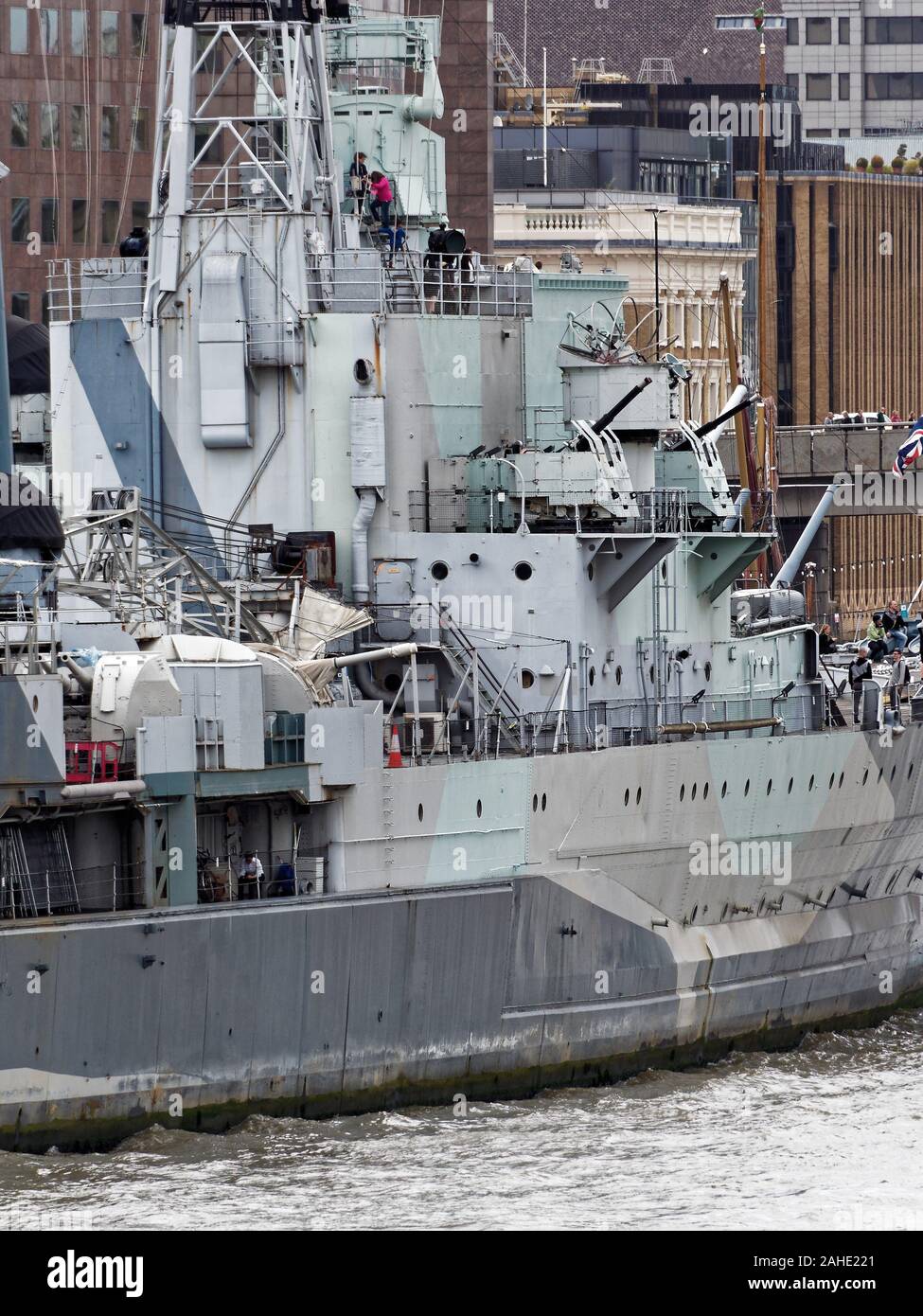 Museum ship light cruiser HMS Belfast on Thames River with Southwark office buildings in the background. London, UK Stock Photo