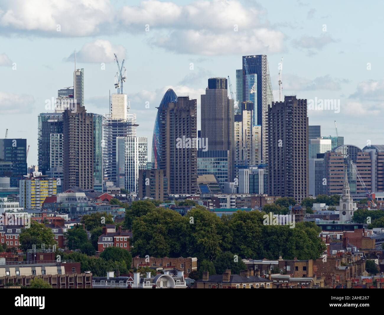 View on the City of London from Kings Cross (north), with residential low-rise buildings and the Barbican complex in front. Stock Photo