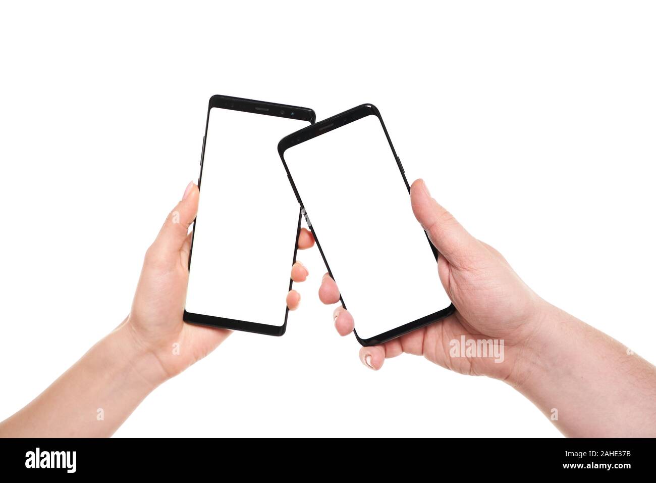 Two hands holding smartphones blank screen with modern frameless design ...