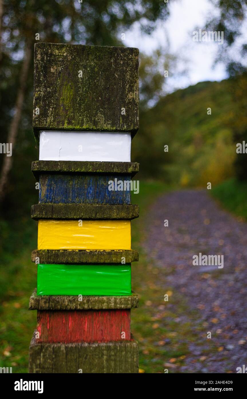 Concept of moving forwards: wooden post on a footpath Stock Photo