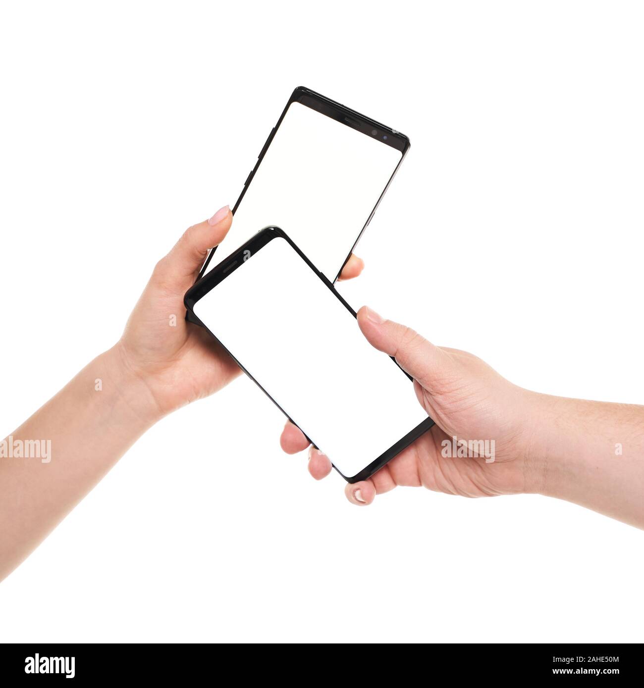 Two hands holding smartphones blank screen with modern frameless design ...