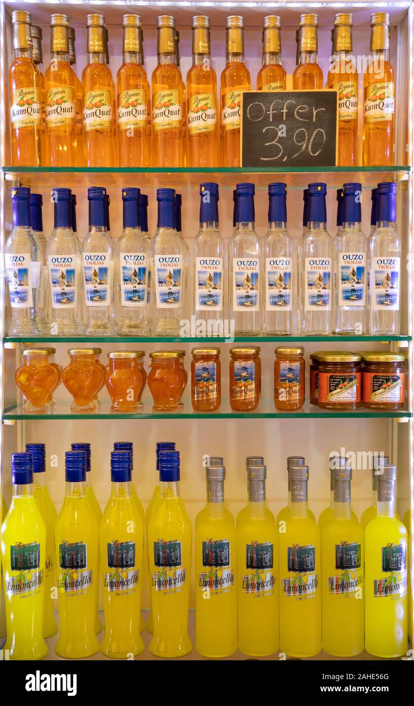 Ouzo and Kumquat liqueur bottles on sale in a souvenir shop in Corfu Town, Greece Stock Photo