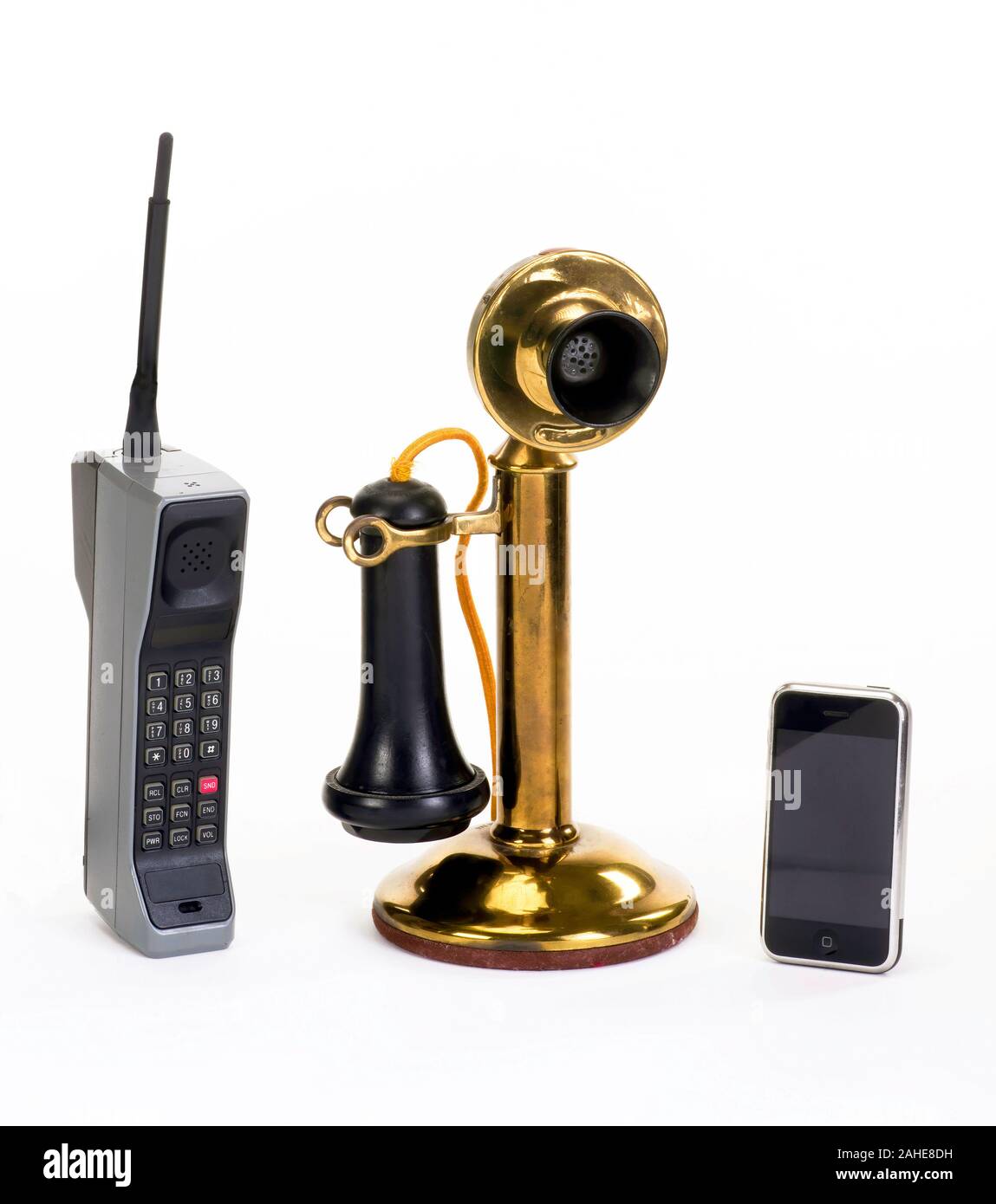 First brick cell phone made around 1980, early candle stick phone made around 1910 and modern smart phone. Stock Photo