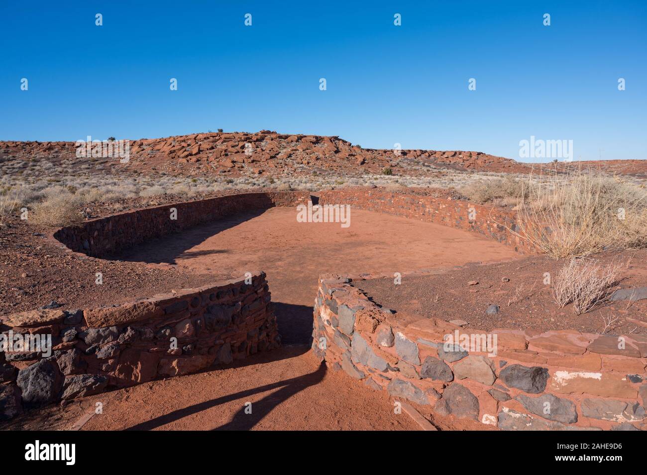 Ancient ruins of the ballcourt next to the Native American house known as the Wupatki Pueblo in