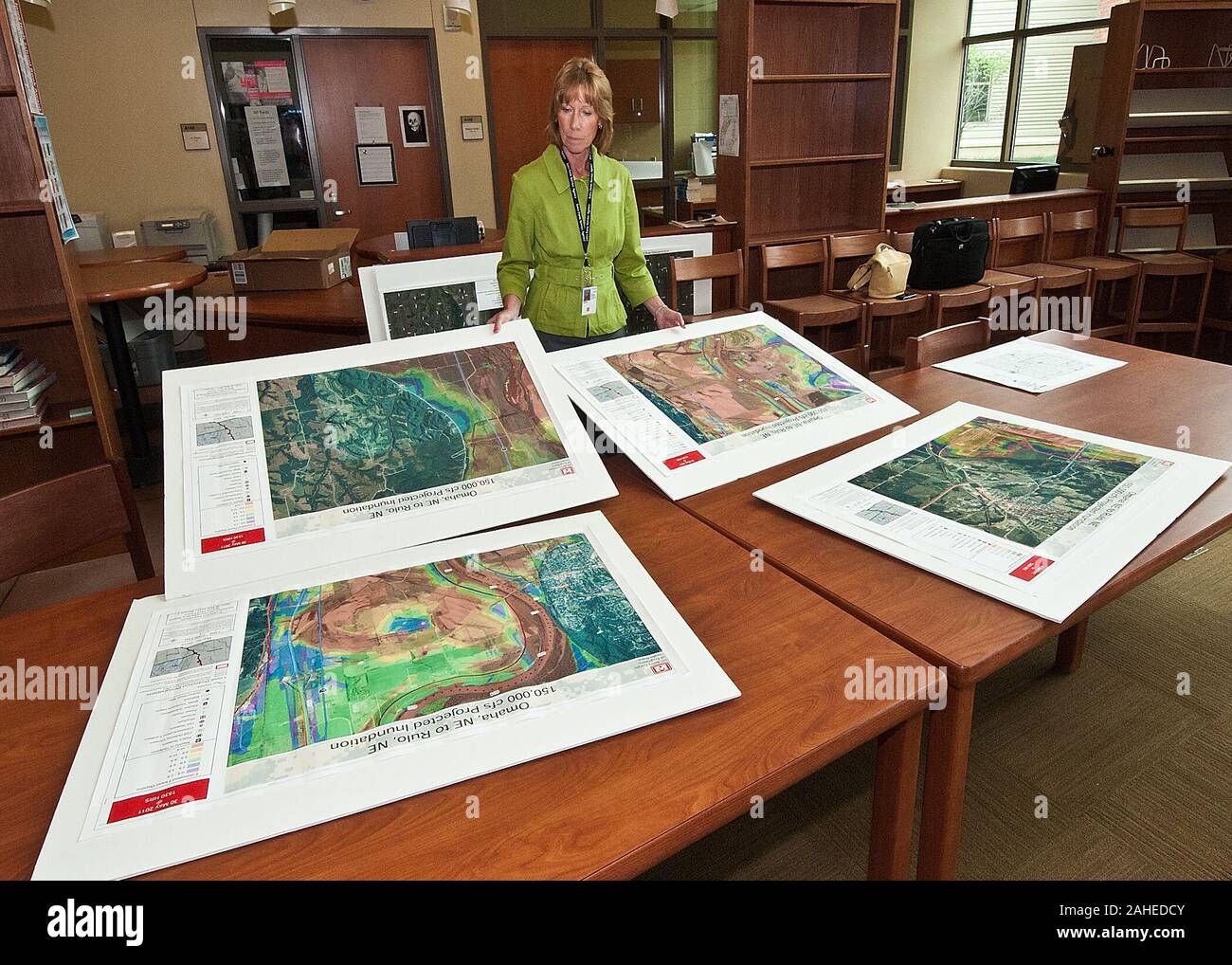 Bobbi Schaaf, Farm Services Agency, District Director, Southwest Iowa prepares An Army Corps of Engineers Inundation Maps representing the possible coverage of the Missouri River floodwaters prior to a town hall meeting held buy Agriculture Secretary Tom Vilsack at the Glenwood Community High School in Glenwood, Iowa Thur., June 16, 2011. Farmers, local and regional media listened and questioned Secretary Vilsack on the cause of the floodwaters along the Missouri River affecting Iowa and Nebraska. Secretary Vilsack offered advice and assistance available through the United States Department of Stock Photo