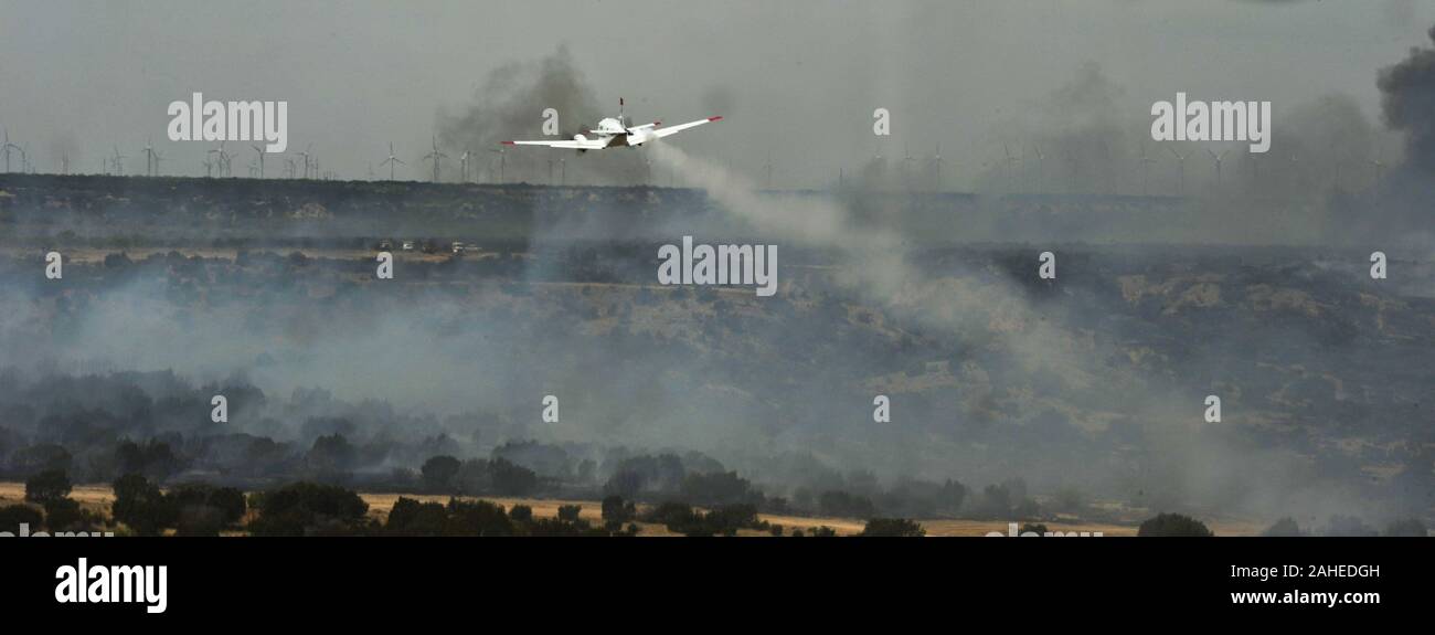 A U.S. Department of Agriculture, Forest Service King Air lead plane guides a C-130J Hercules from the 146th Airlift Wing during firefighting operations in Scurry County, Texas, April 26. The lead planes guide aircraft to ensure that the fire retardant is dispensed where it is needed.  Wildfires have spread across various parts of Texas and have burned more than 1,000 square miles of land. Stock Photo
