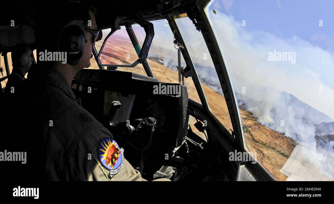 U.S. Air Force Maj. Kevin DeHart, 115th Airlift Squadron, California Air National Guard, prepares to drop a line of fire retardant while aboard a C-130J Hercules over West Texas, April 27. The C-130 is equipped with the Modular Airborne Firefighting System which is capable of dispensing 3,000 gallons of water or fire retardant in under 5 seconds. The wildfires have spread across various parts of Texas and have burned more than 1,000 square miles of land. Stock Photo
