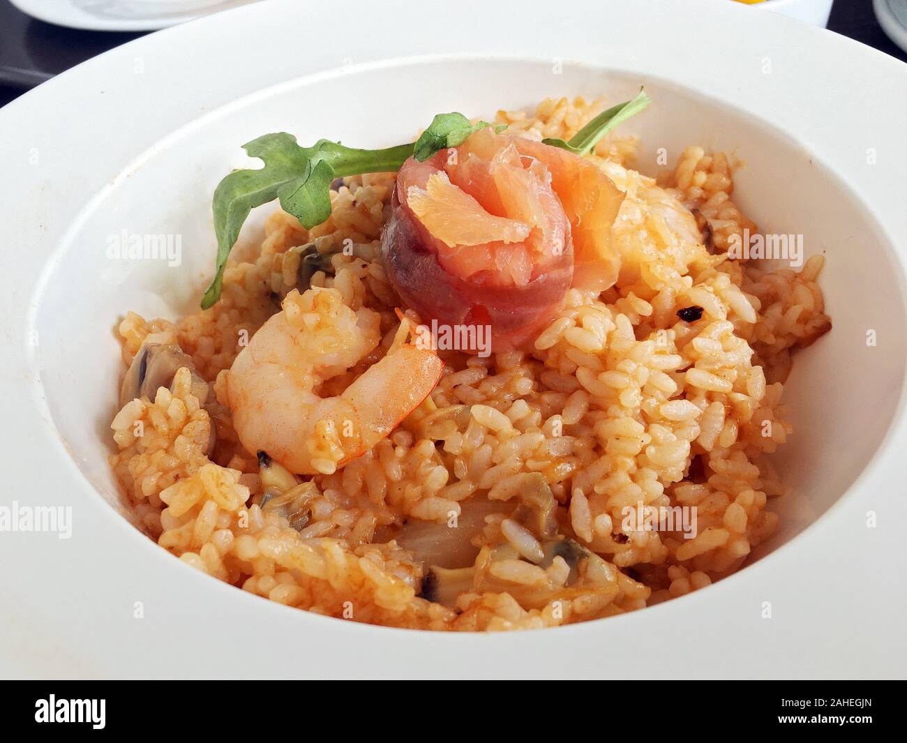 Traditional Italy risotto tomato shrimp salmon fire rice cafe Stock Photo