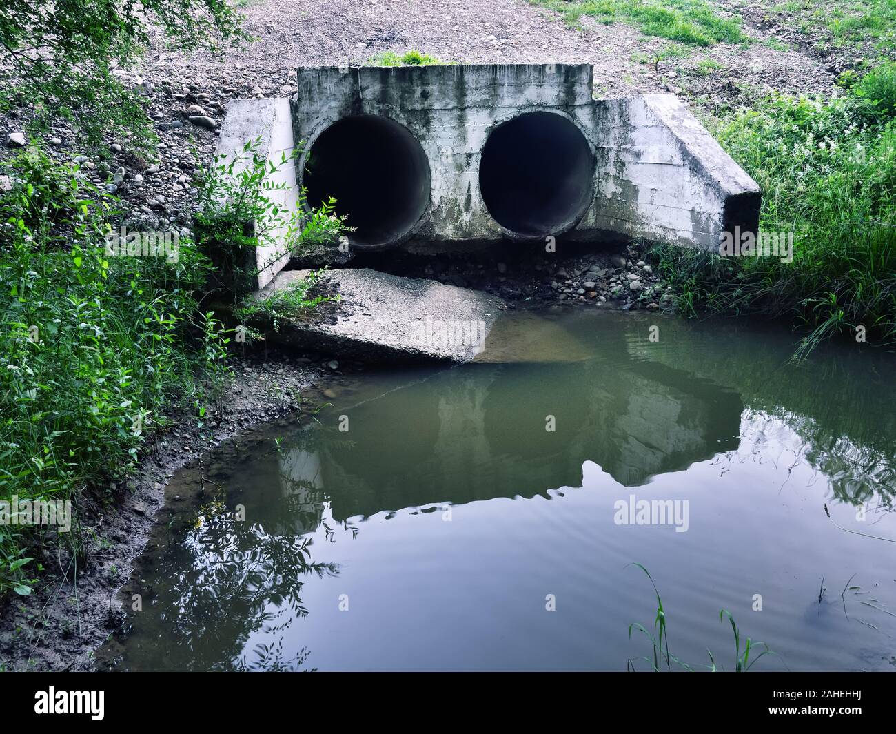 road construction drainage pipe under highway with flow of water Stock