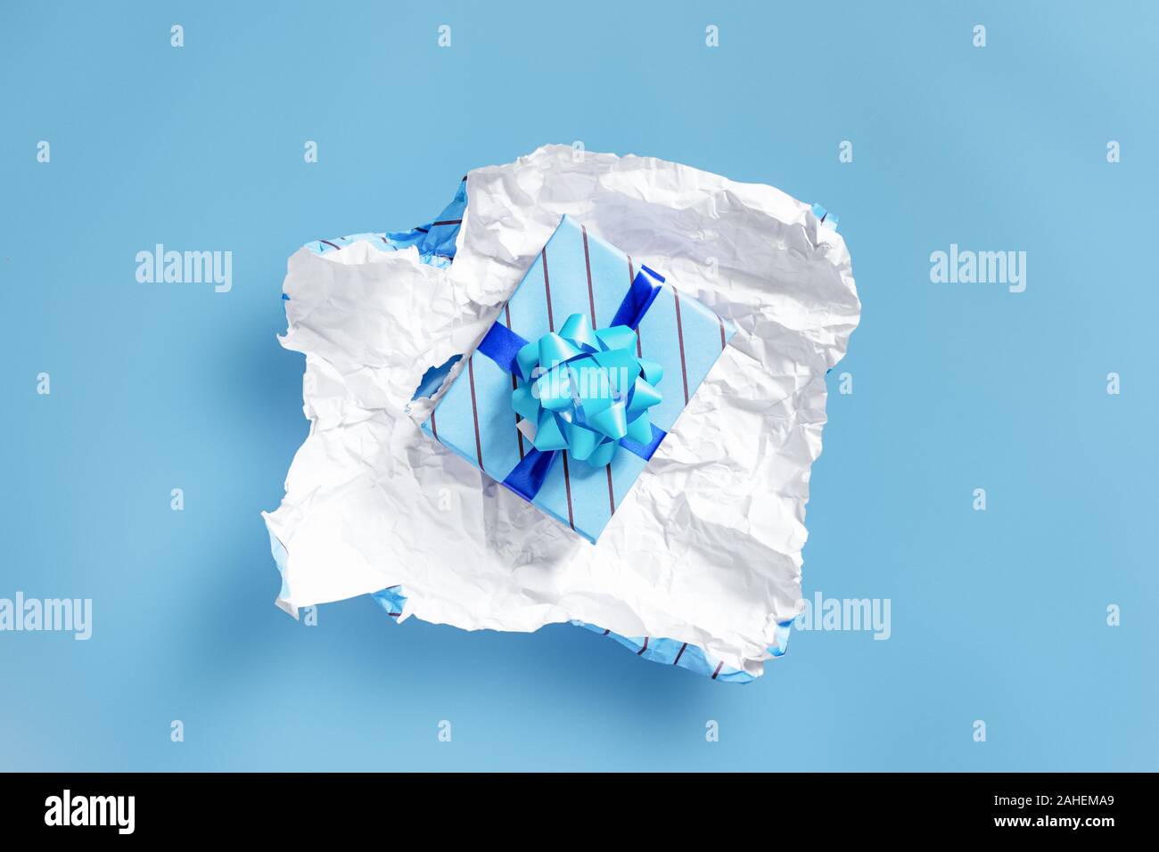 unwrapping present to find another layer of wrapping - Celebrations and events concept image with copy space for text. Stock Photo