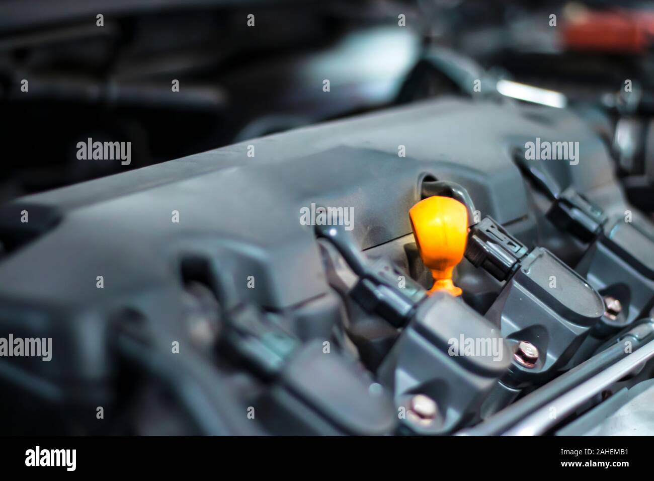 Petrol engine and orange oil dipstick Stock Photo Alamy