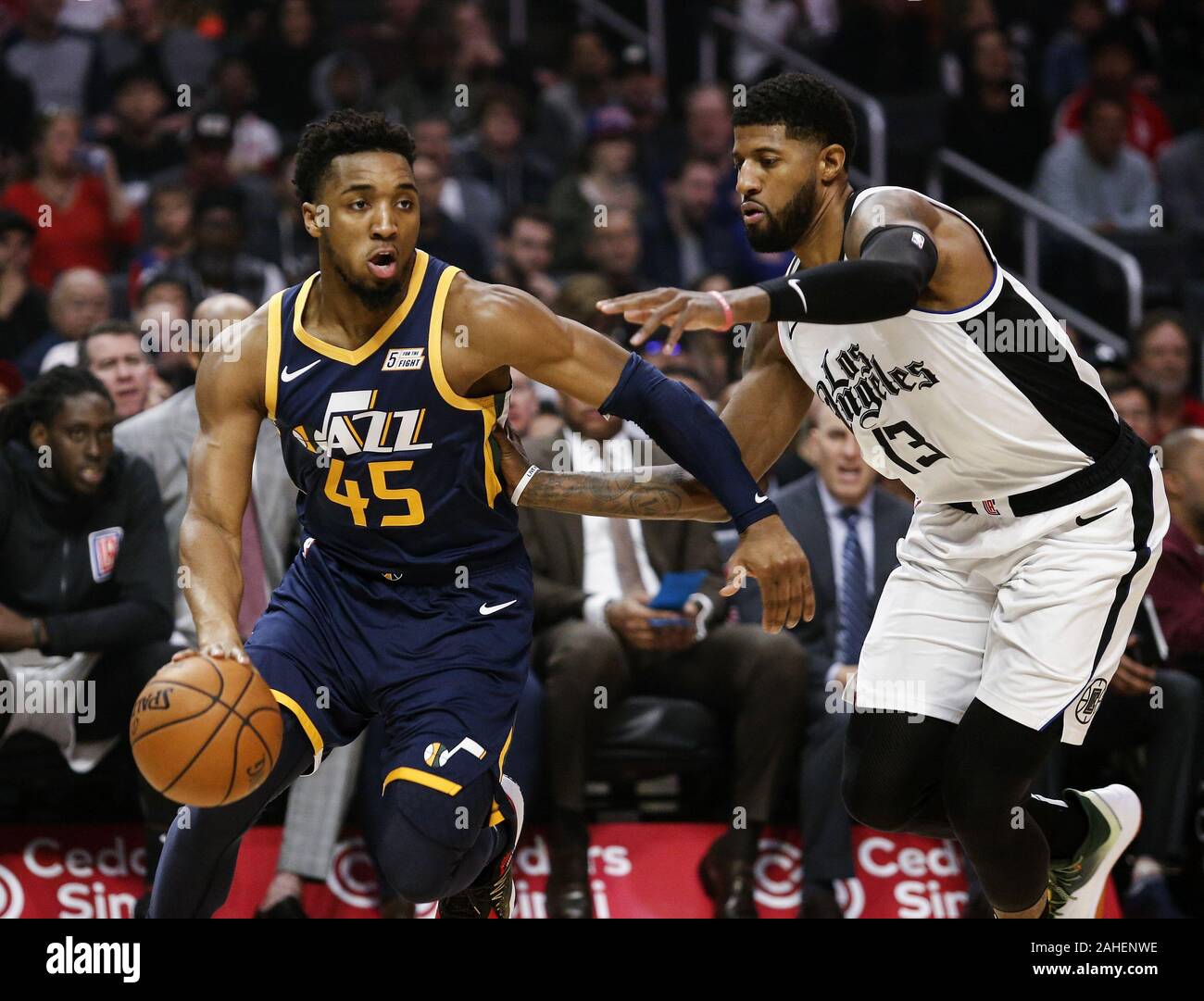 Los Angeles, California, USA. 28th Dec, 2019. Utah Jazz's Donovan Mitchell (45) drives against Los Angeles Clippers' Paul George (13) during an NBA basketball game between Los Angeles Clippers and Utah Jazz, Saturday, December 28, 2019, in Los Angeles. Credit: Ringo Chiu/ZUMA Wire/Alamy Live News Stock Photo