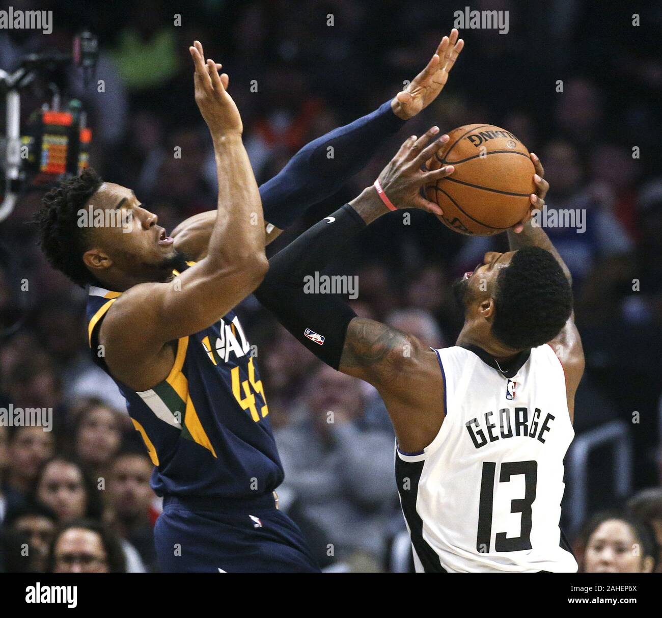 Los Angeles, California, USA. 28th Dec, 2019. Los Angeles Clippers' Paul George (13) goes up to basket while defended by Utah Jazz's Donovan Mitchell (45) during an NBA basketball game between Los Angeles Clippers and Utah Jazz, Saturday, December 28, 2019, in Los Angeles. Credit: Ringo Chiu/ZUMA Wire/Alamy Live News Stock Photo