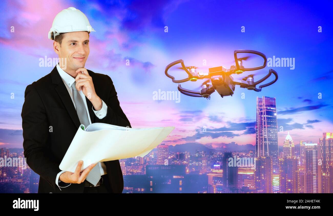 Drone operated by construction worker on building site Stock Photo