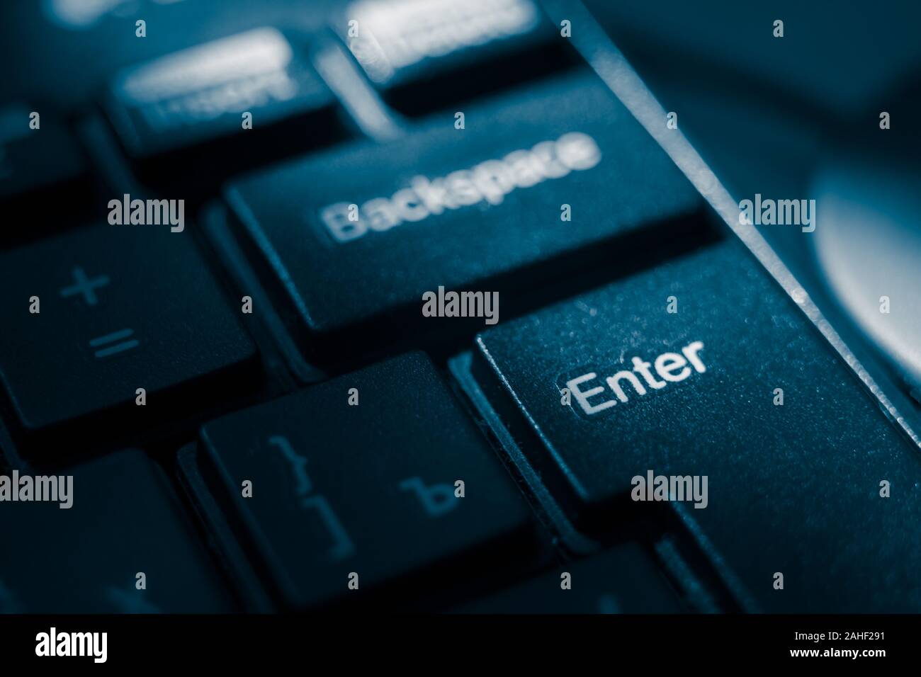 Black shiny keyboard closeup, focus on the Enter key Stock Photo Alamy