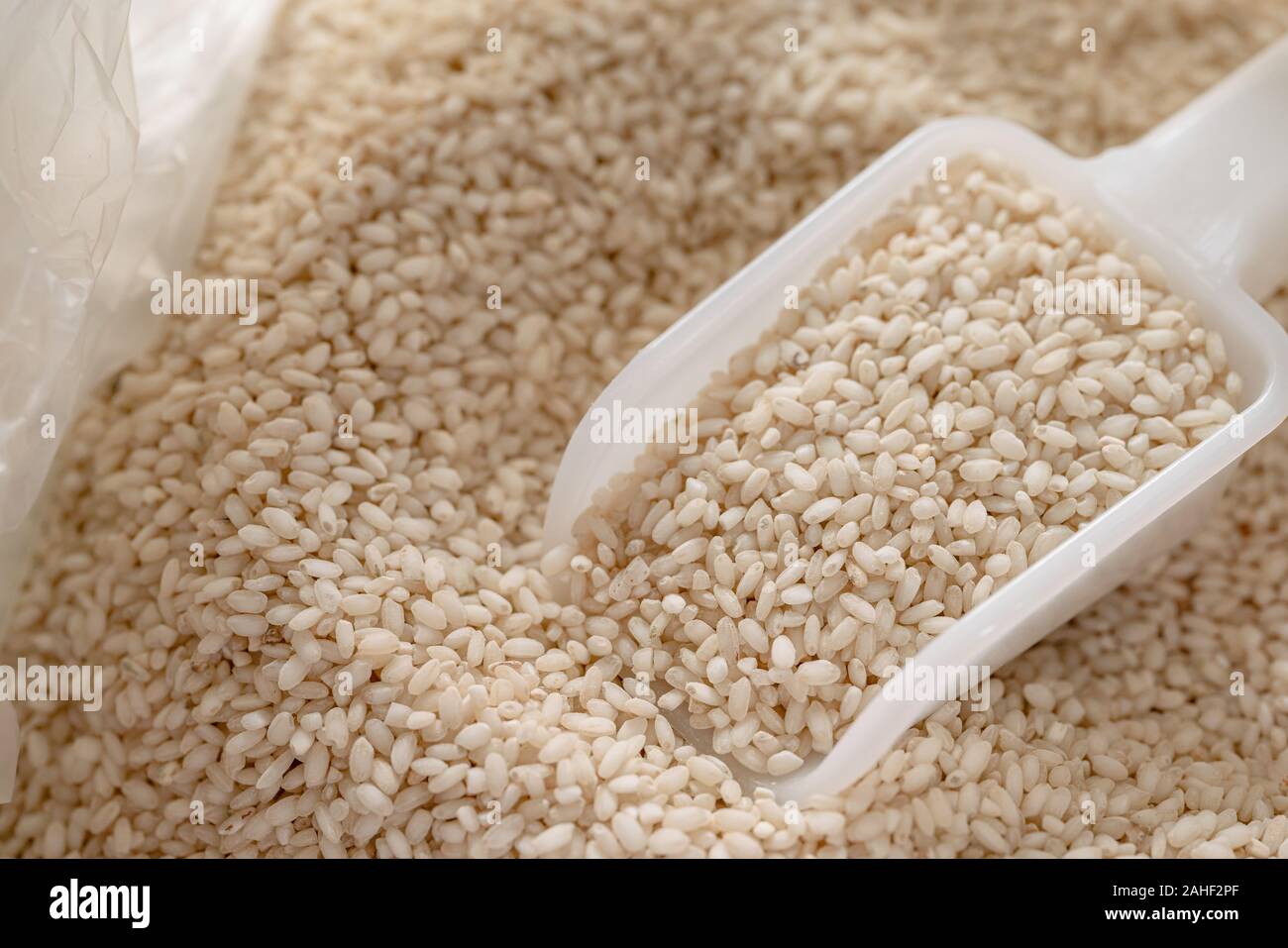 seeds Short rice with spoon on rice background,Close up Stock Photo - Alamy