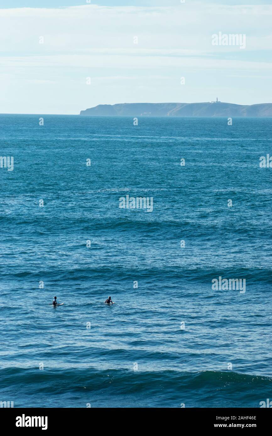 Two surfers in the sea at Papoa Point Peniche Estremadura Portugal Stock Photo