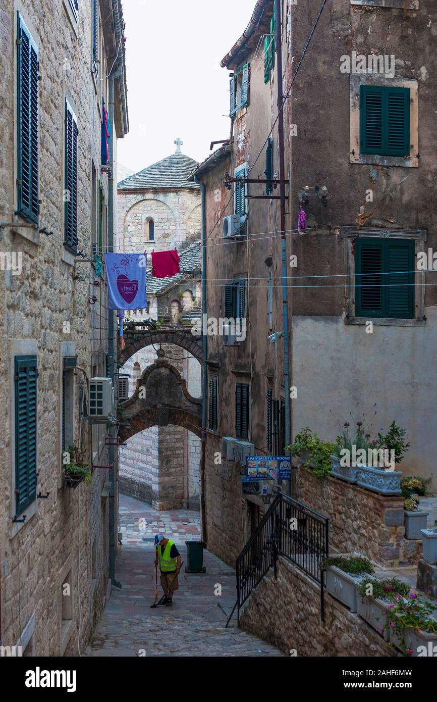 Early morning street-cleaning in the lane leading down from the Fort of St. Ivan, Kotor, Montenegro Stock Photo