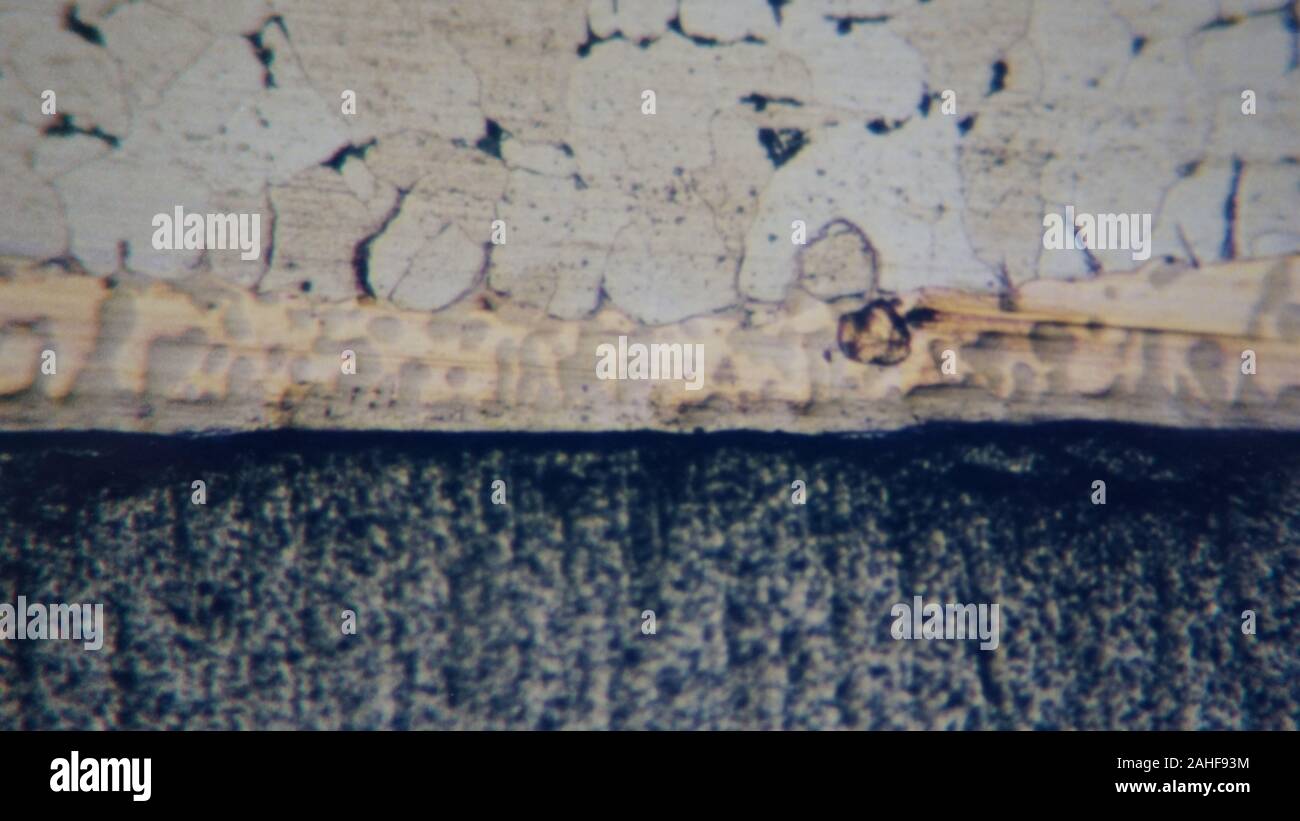metallurgical micrograph of a copper brazed joint between tungsten carbide and dead mild steel