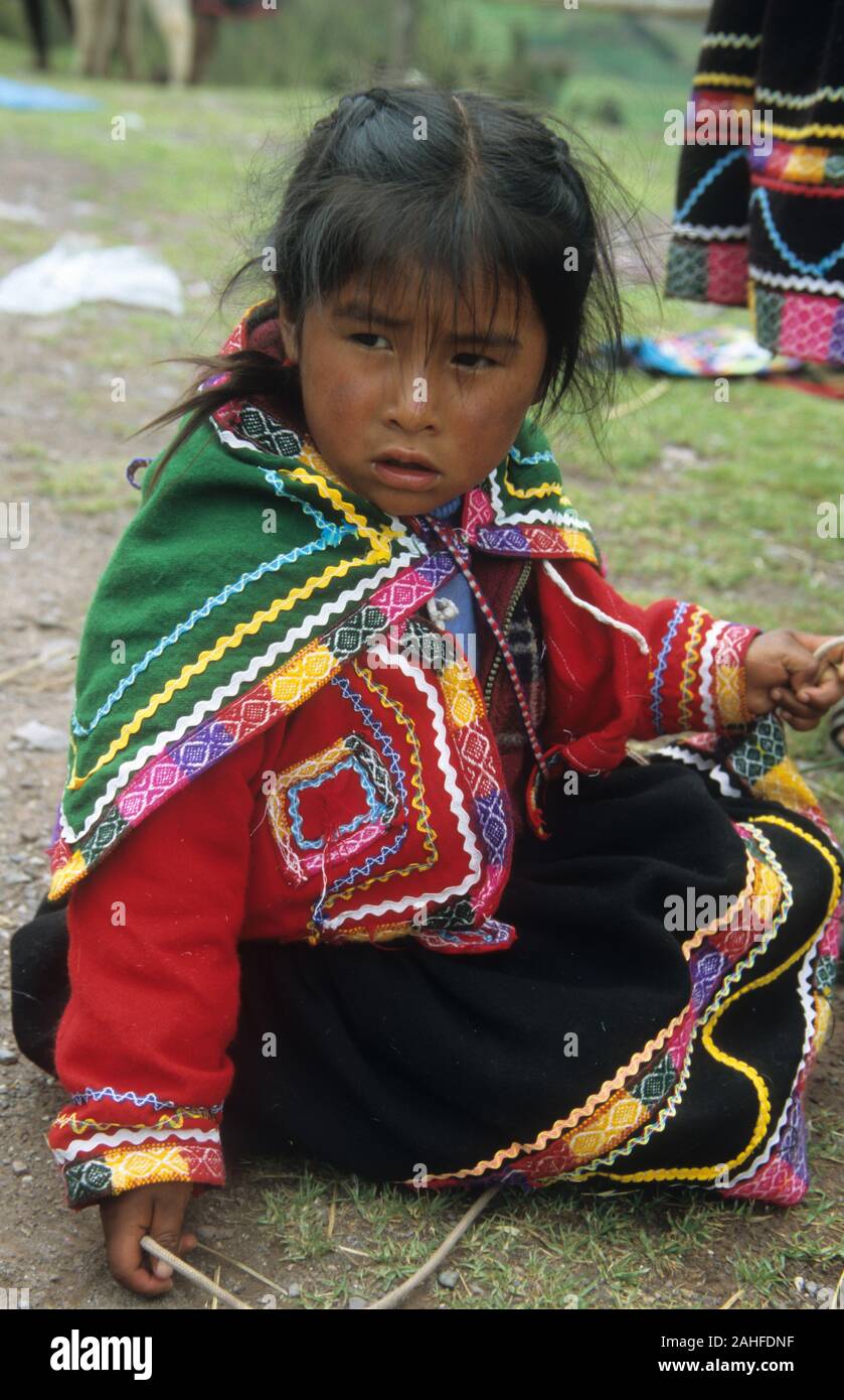 Indigenous child in colourful clothes, Cusco, Peru Stock Photo