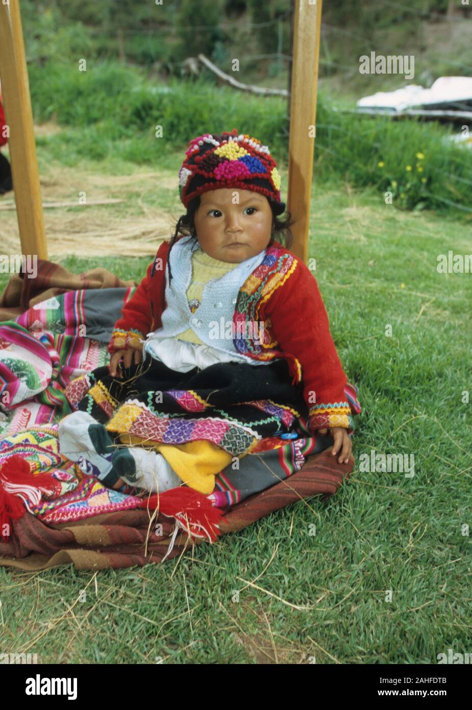 Indigenous child in colourful clothes, Cusco, Peru Stock Photo